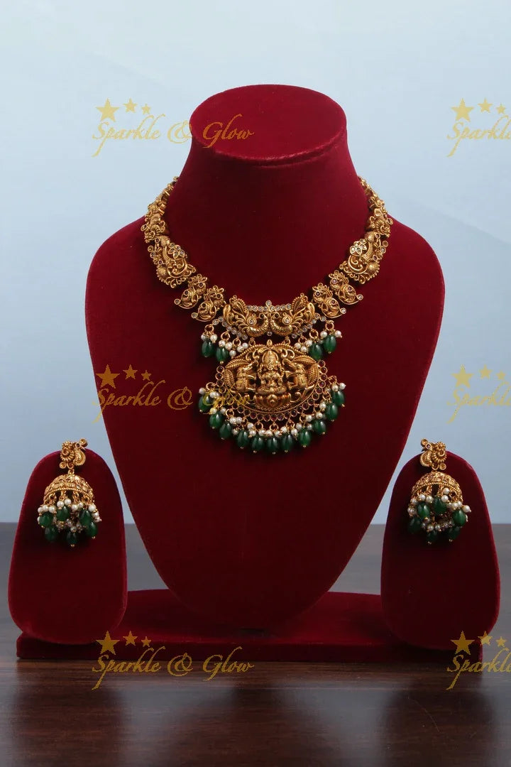Intricately Carved Gold Alike Polished Lakshmi Elephant Short Necklace With Green Beads - Sparkle and Glow