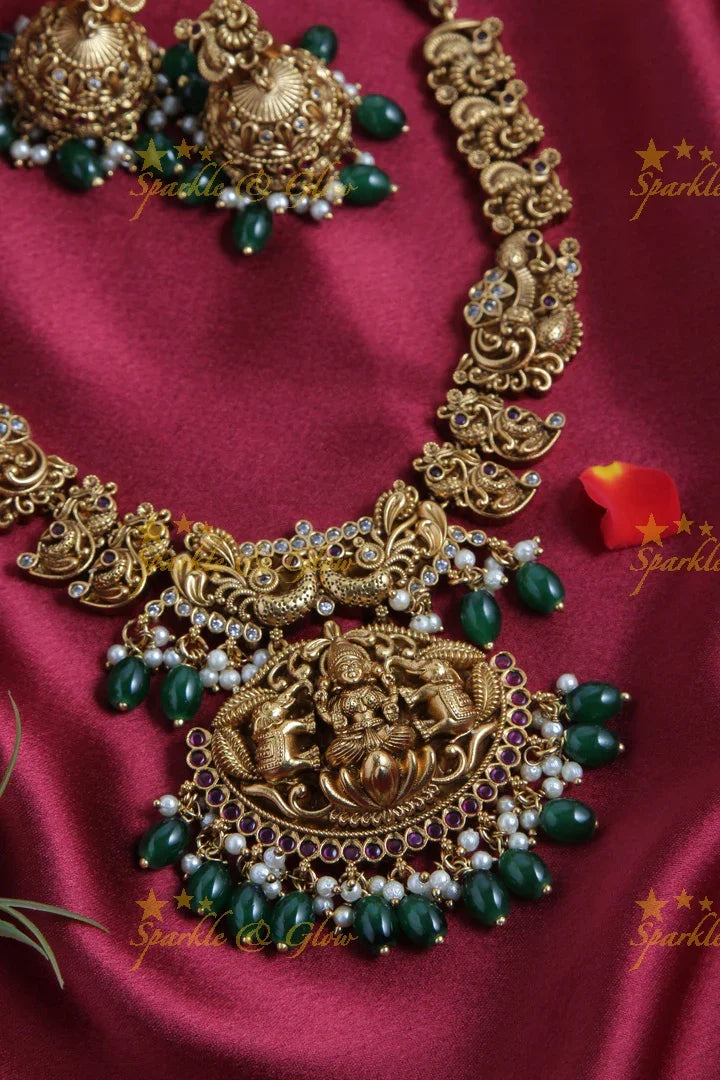 Intricately Carved Gold Alike Polished Lakshmi Elephant Short Necklace With Green Beads - Sparkle and Glow
