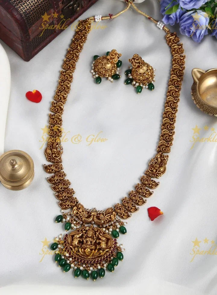 Intricately Carved Gold Alike Polished Lakshmi Elephant Long Necklace With Green Beads - Sparkle and Glow