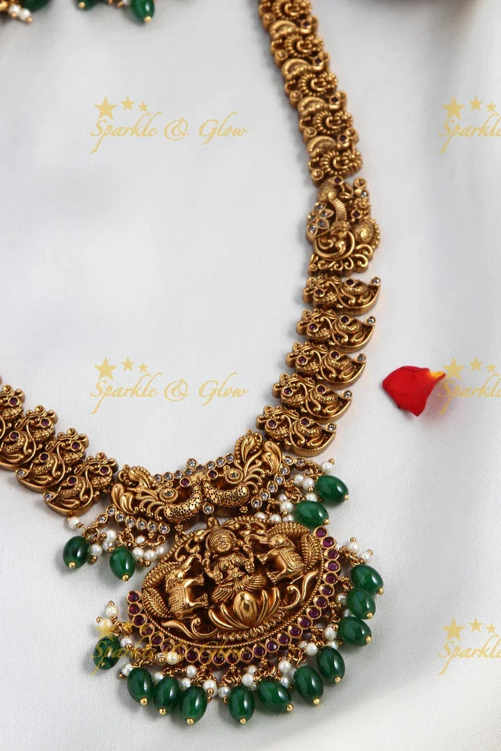 Intricately Carved Gold Alike Polished Lakshmi Elephant Long Necklace With Green Beads - Sparkle and Glow