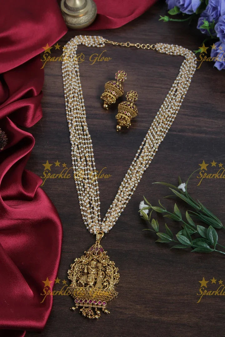 Multilayered Pearl Haram with beautiful Lord Radha Krishan Plaing flute pendent - Sparkle and Glow