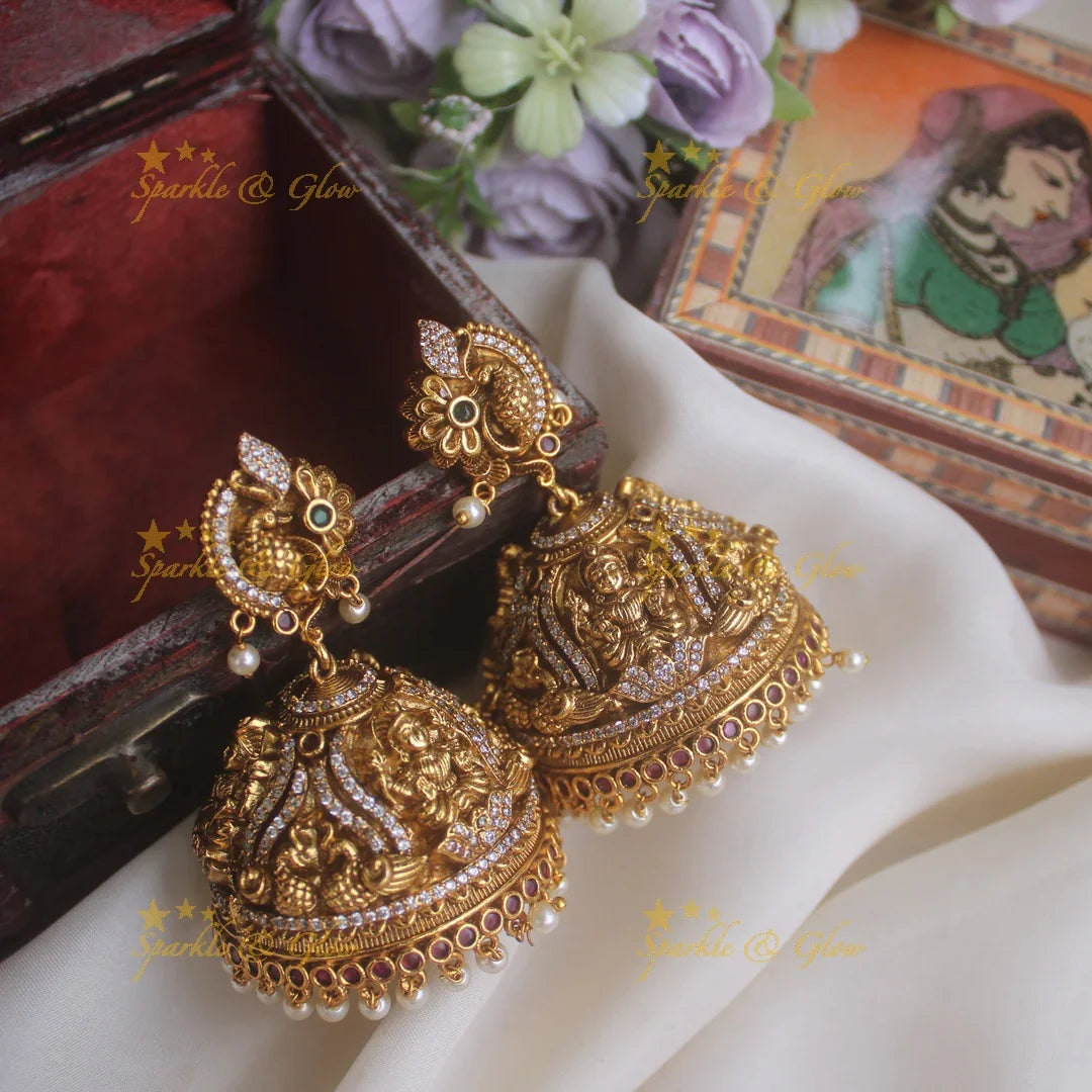 Beautiful peacock studded lakshmi carved heavy jhumkas - Sparkle and Glow
