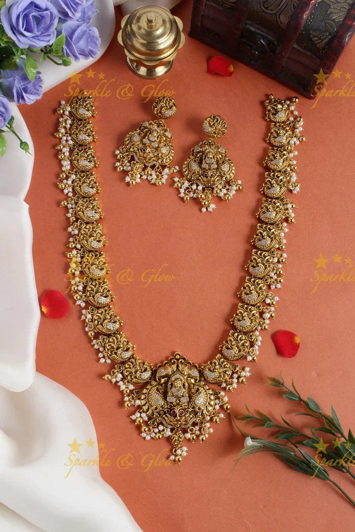 Gold alike long peacock necklace with lakshmi carved pendent - Sparkle and Glow