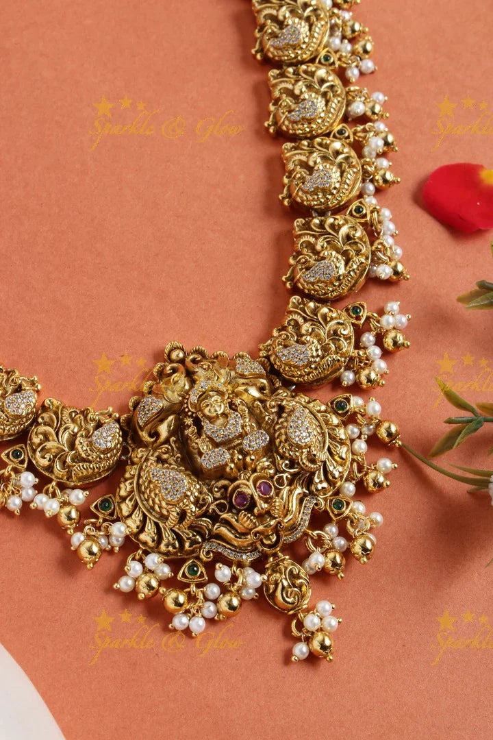 Gold alike long peacock necklace with lakshmi carved pendent - Sparkle and Glow