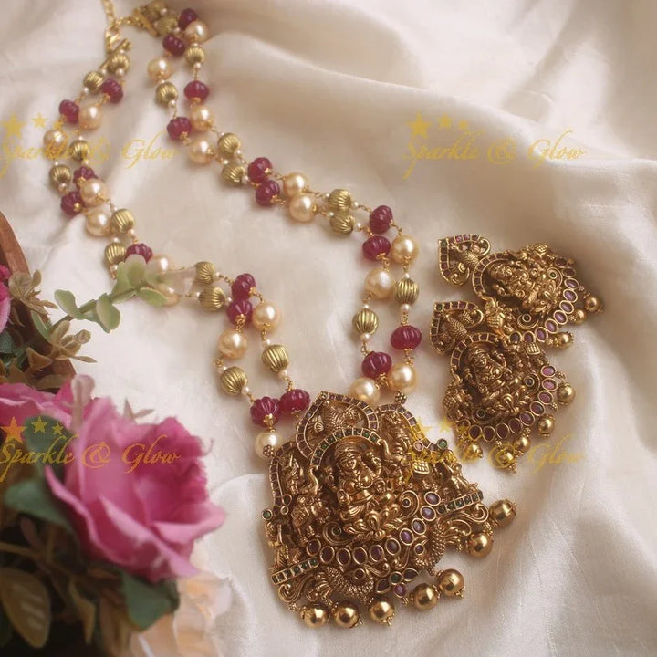 Gold alike Elegant Lakshmi carved pendent set with green pink stones - Sparkle and Glow