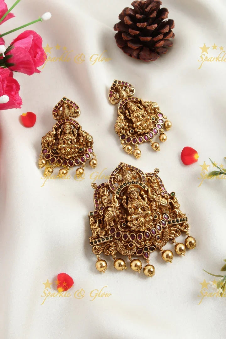 Gold alike Elegant Lakshmi carved pendent set with green pink stones - Sparkle and Glow