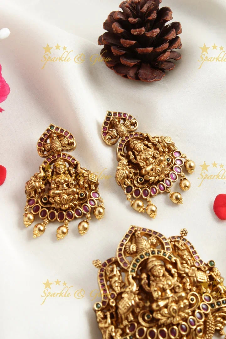 Gold alike Elegant Lakshmi carved pendent set with green pink stones - Sparkle and Glow