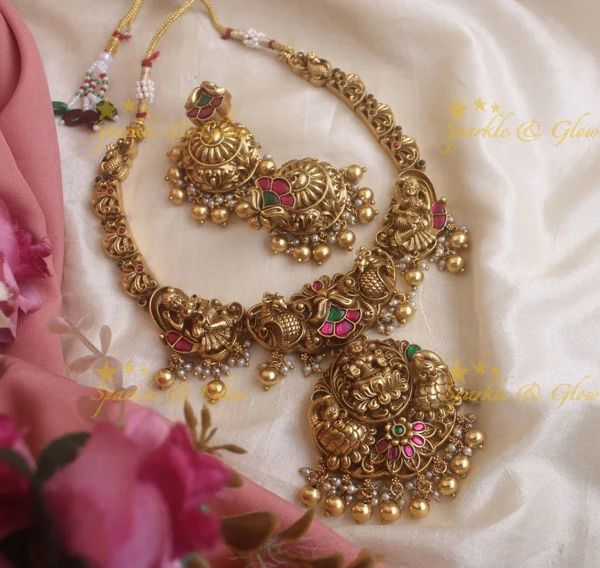 Statement Lakshmi and peacock carved jadau short necklace with red and green stones gold beads - Sparkle and Glow