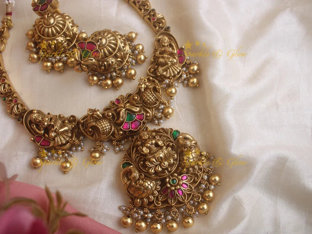 Statement Lakshmi and peacock carved jadau short necklace with red and green stones gold beads - Sparkle and Glow