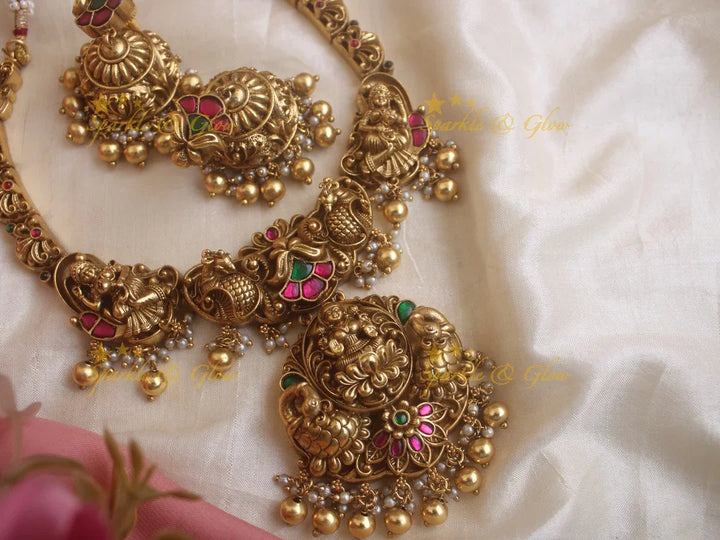 Statement Lakshmi and peacock carved jadau short necklace with red and green stones gold beads - Sparkle and Glow