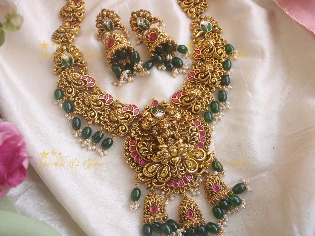 Grand Intricate gold alike Jadau Lakshmi and peacock carved long necklace with gold beads - Sparkle and Glow