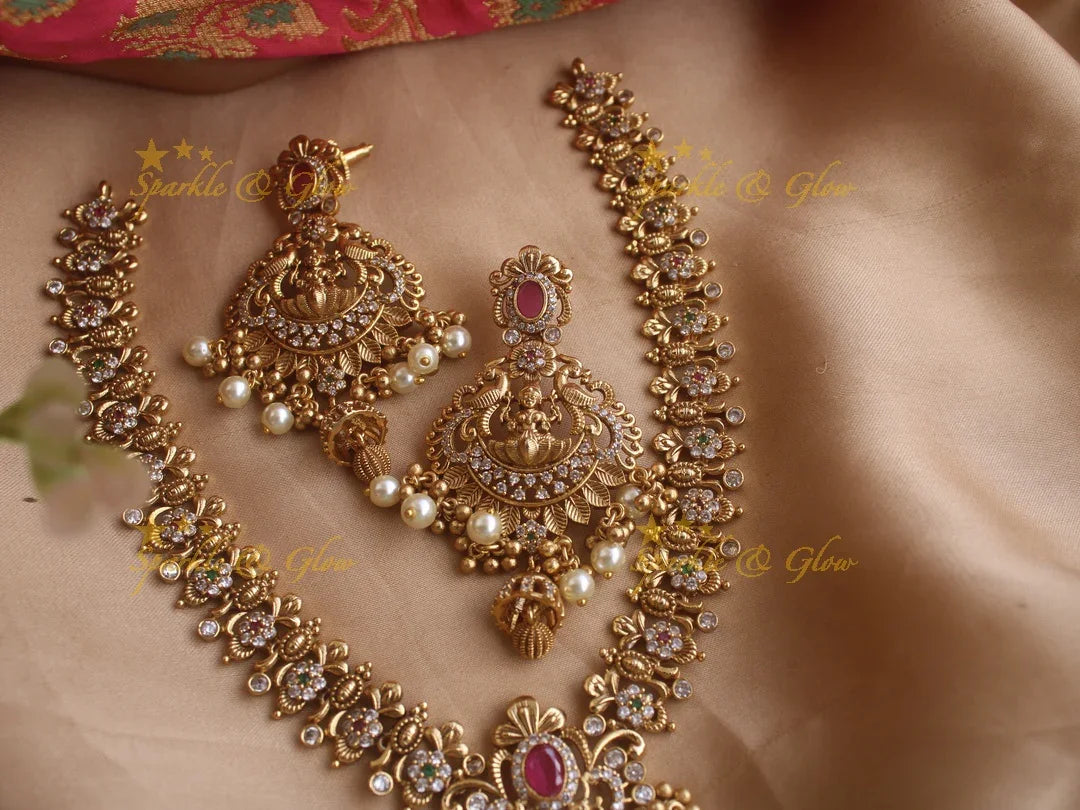 Stunning premium dull matte finish Lakshmi and peacock carved short necklace with cz stones and pearls - Sparkle and Glow