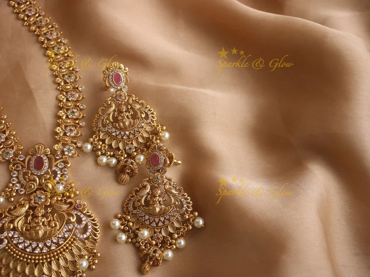 Stunning premium dull matte finish Lakshmi and peacock carved long necklace with stones and pearls - Sparkle and Glow