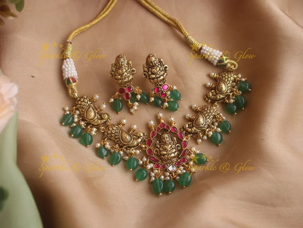 Beautiful gold alike Lakshmi and peacock carved high neck choker with green beads - Sparkle and Glow