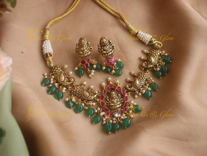 Beautiful gold alike Lakshmi and peacock carved high neck choker with green beads - Sparkle and Glow