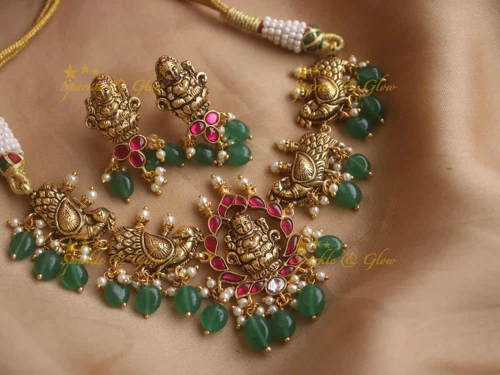 Beautiful gold alike Lakshmi and peacock carved high neck choker with green beads - Sparkle and Glow