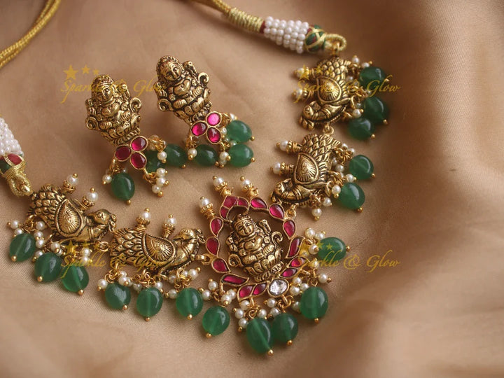 Beautiful gold alike Lakshmi and peacock carved high neck choker with green beads - Sparkle and Glow