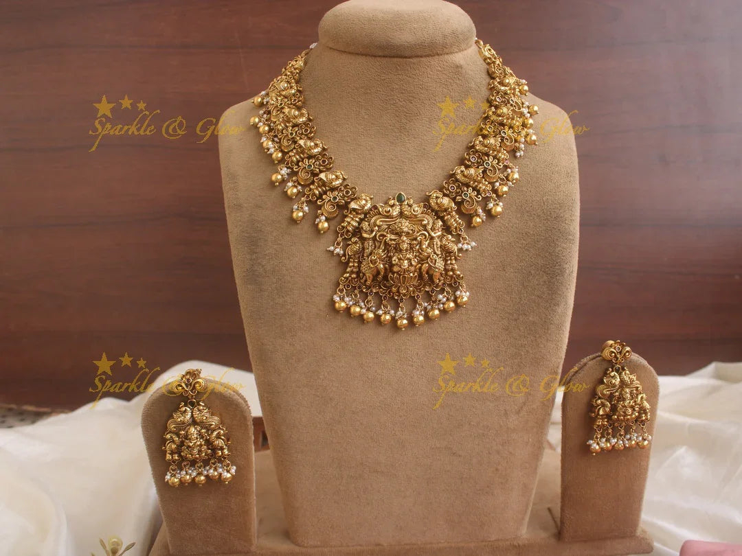 Exquisite Lakshmi Elephant and peacock carved short necklace with red green stones and gold beads - Sparkle and Glow