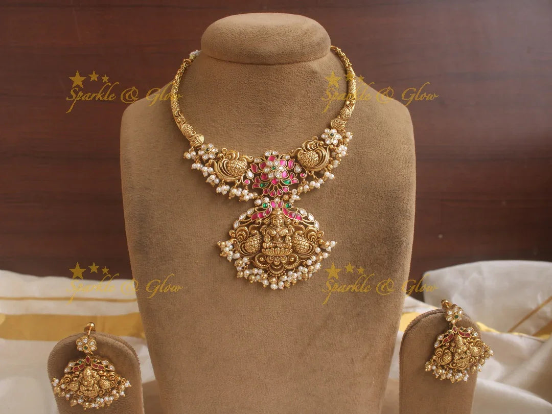 Beautiful Lakshmi peacock and floral design jadau short necklace with pink green and white stones and pearls - Sparkle and Glow