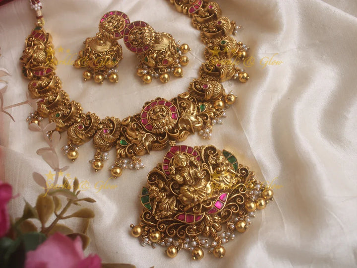 Exquisite Lotus and peacock carved jadau short necklace with pink and green stones and gold beads - Sparkle and Glow