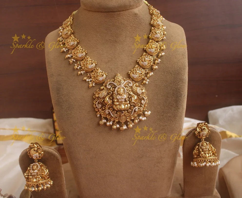 Exquisite gold alike Lakshmi and peacock carved short necklace with pearls and gold beads - Sparkle and Glow