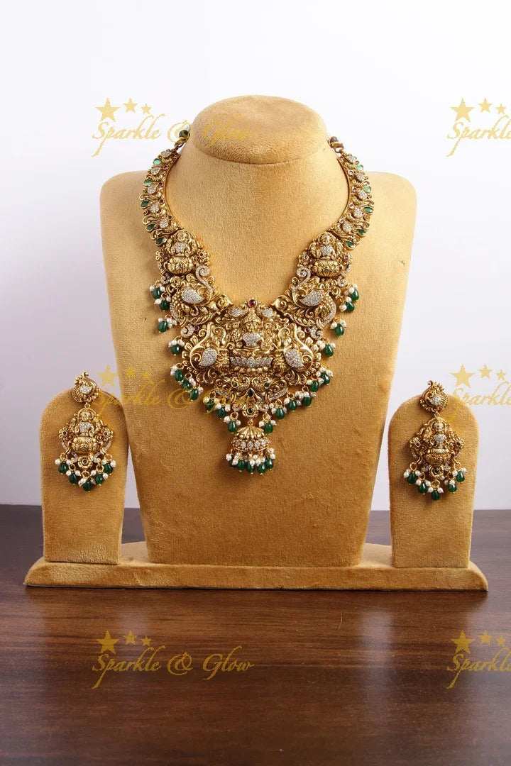 Grand Gold alike Lakshmi carved bridal necklace with emerald and gold beads - Sparkle and Glow
