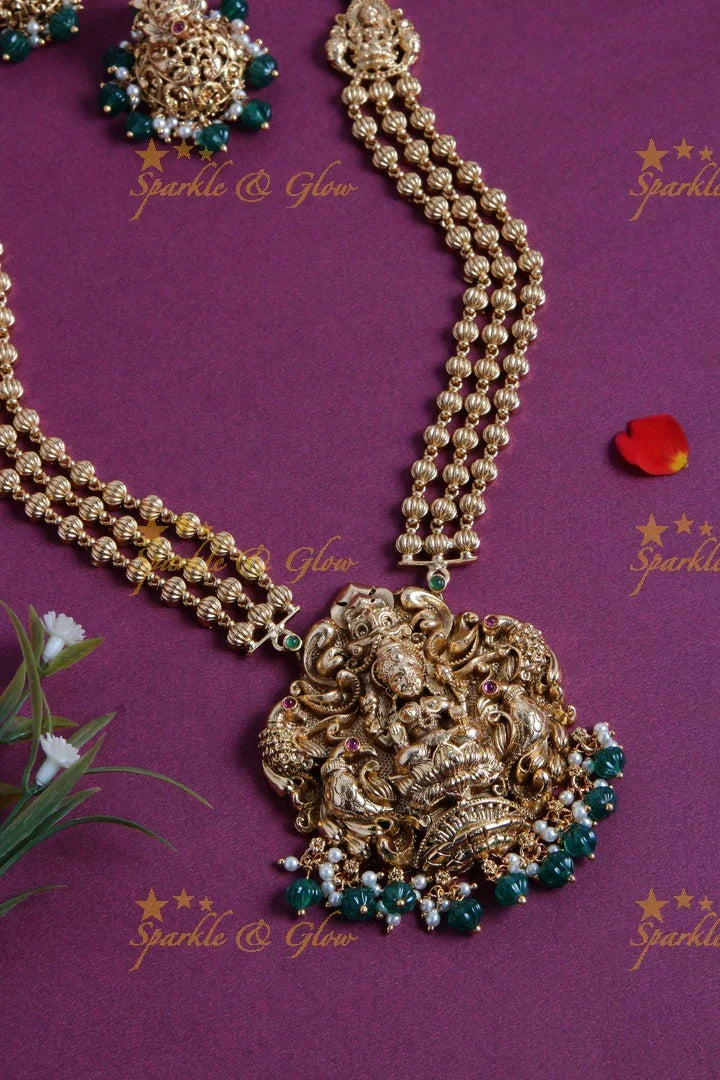 Gold Alike Lakshmi peacock carved pendent multi layer gold beads haram with green beads - Sparkle and Glow