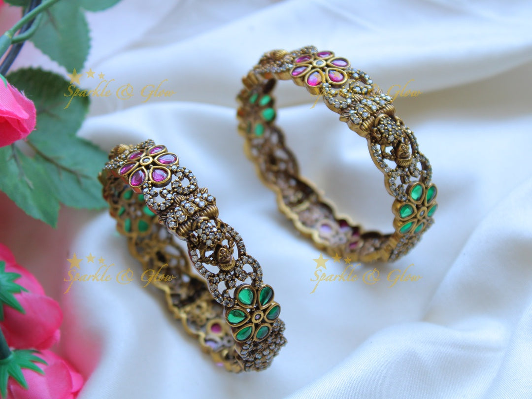 Exclusive Lakshmi and floral design victorian bangles with ruby and emerald a pair,