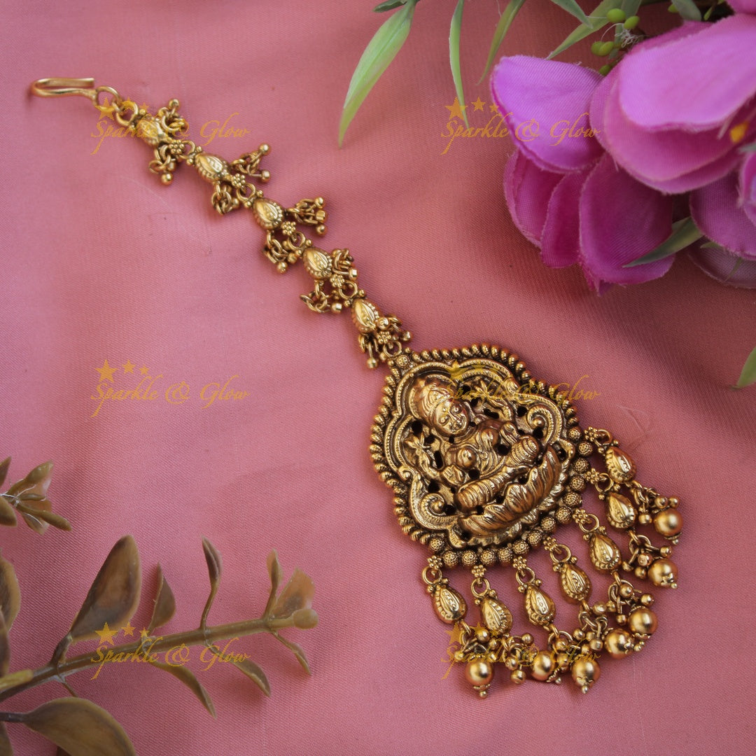 Gold alike Lakshmi carved gutta pusalu maang tikka with green beads