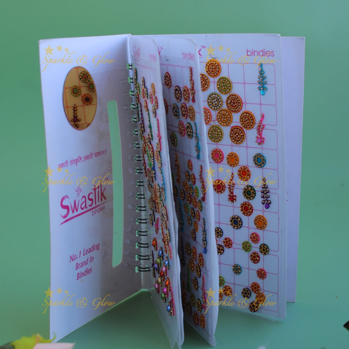 Swastik bridal stone bindi with different shape and size in spiral book in assorted colours