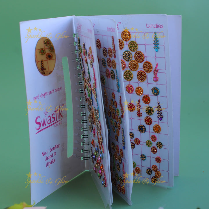 Swastik bridal stone bindi with different shape and size in spiral book in assorted colours