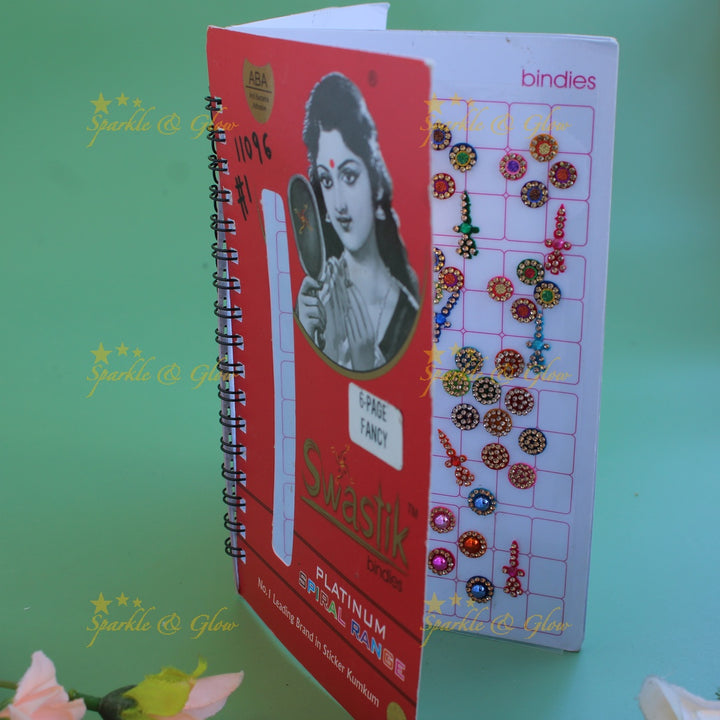 Swastik bridal stone bindi with different shape and size in spiral book in assorted colours