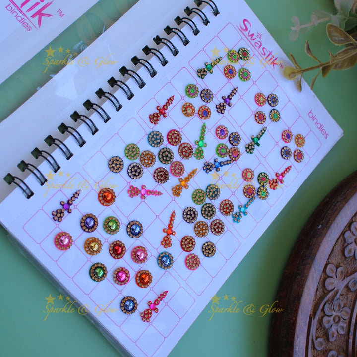 Swastik bridal stone bindi with different shape and size in spiral book in assorted colours
