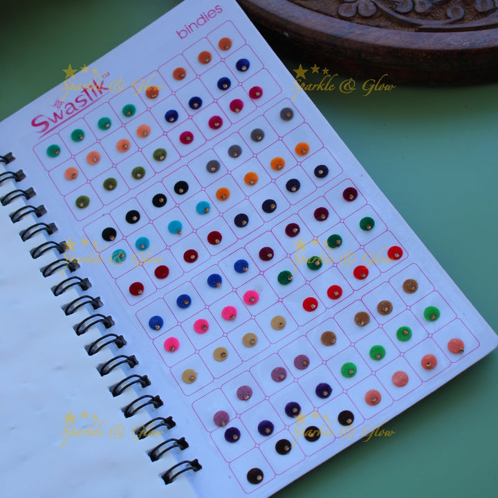 Swastik round shape single stone bindi with different size in spiral book in assorted colours