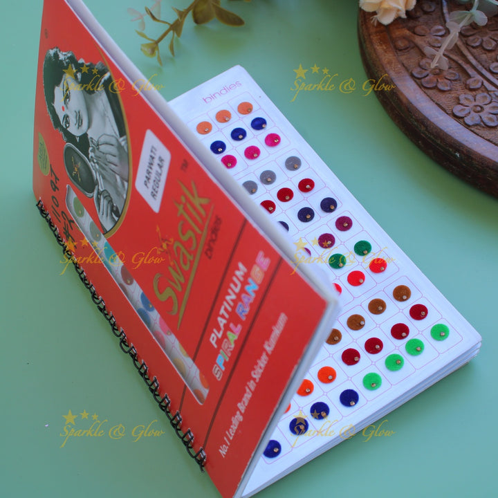 Swastik round shape single stone bindi with different size in spiral book in assorted colours