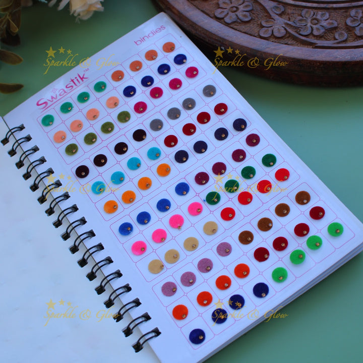 Swastik round shape single stone bindi with different size in spiral book in assorted colours