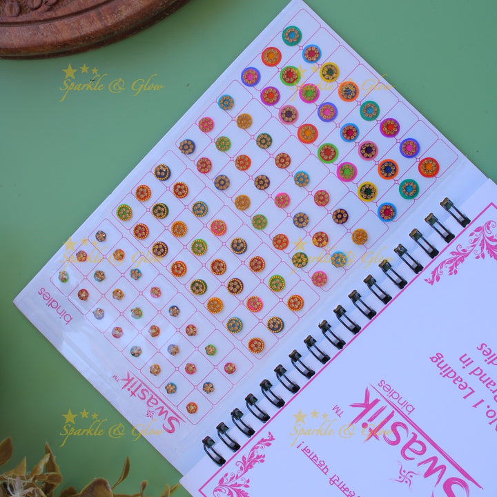Swastik stone bindi with different shape and size in spiral book in assorted colours