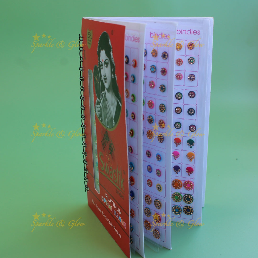 Swastik stone bindi with different shape and size in spiral book in assorted colours