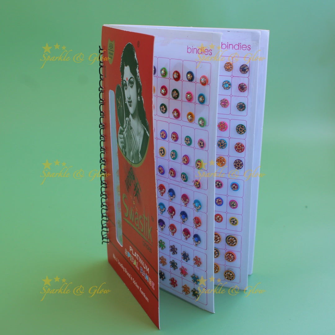 Swastik stone bindi with different shape and size in spiral book in assorted colours