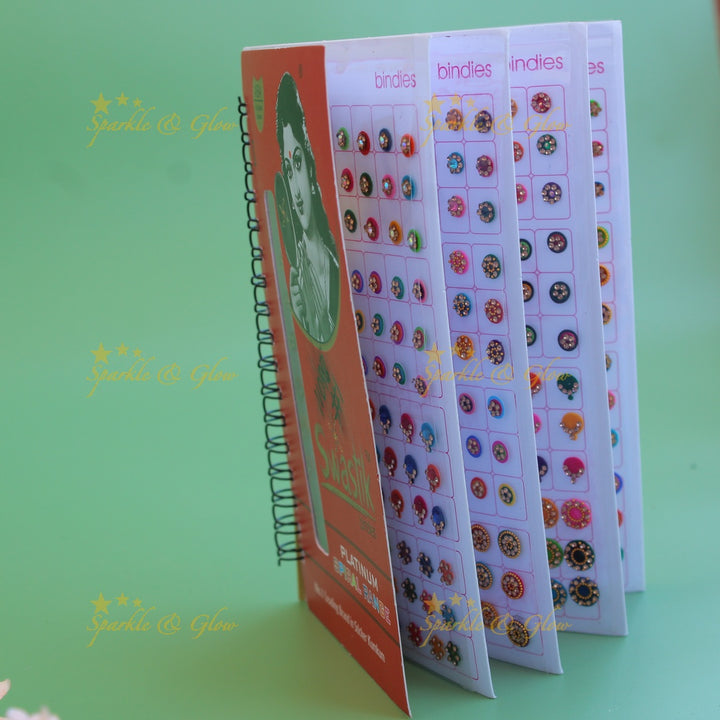 Swastik stone bindi with different shape and size in spiral book in assorted colours