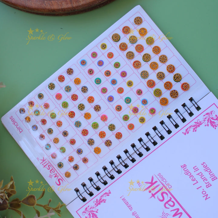 Swastik stone bindi with different shape and size in spiral book in assorted colours