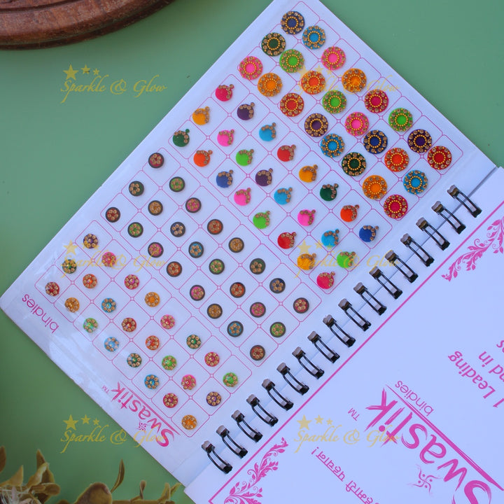 Swastik stone bindi with different shape and size in spiral book in assorted colours
