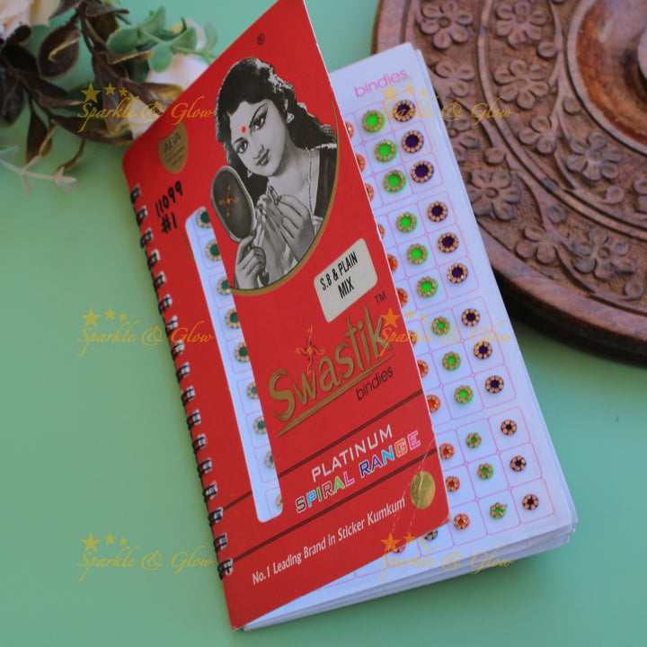 Swastik round stone and plain bindi with different size in spiral book in assorted colours