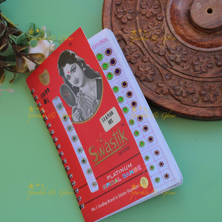 Swastik round stone and plain bindi with different size in spiral book in assorted colours