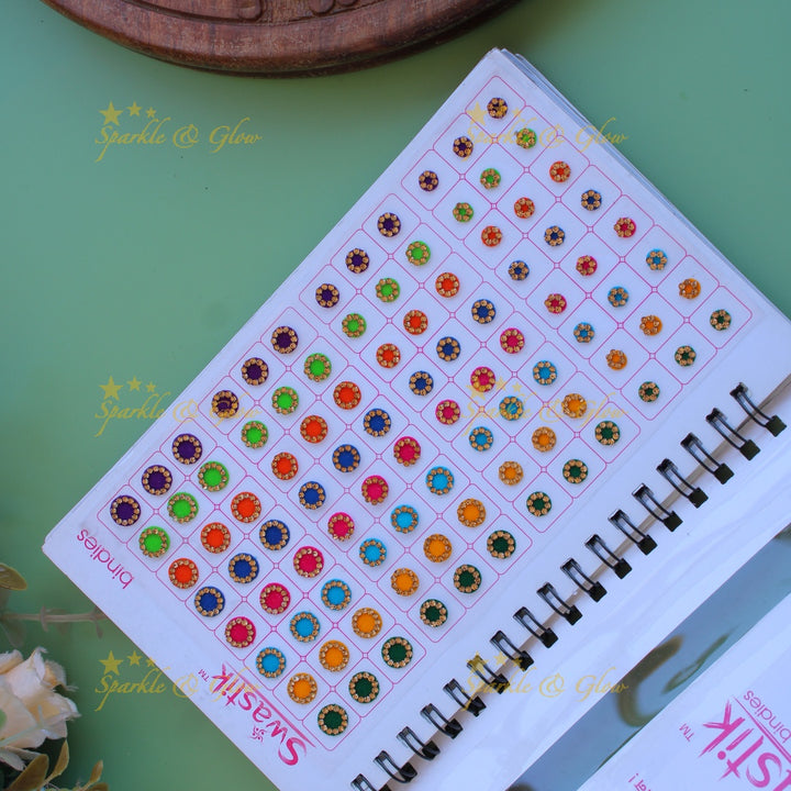 Swastik round stone and plain bindi with different size in spiral book in assorted colours