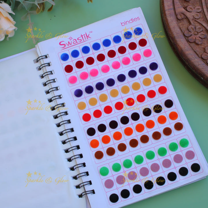 Swastik round stone and plain bindi with different size in spiral book in assorted colours