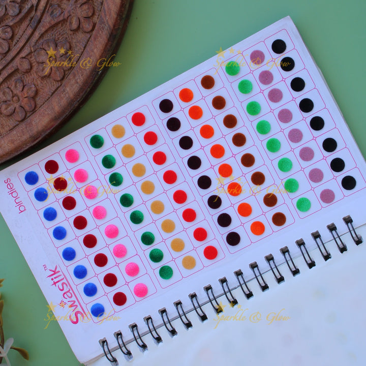 Swastik round stone and plain bindi with different size in spiral book in assorted colours