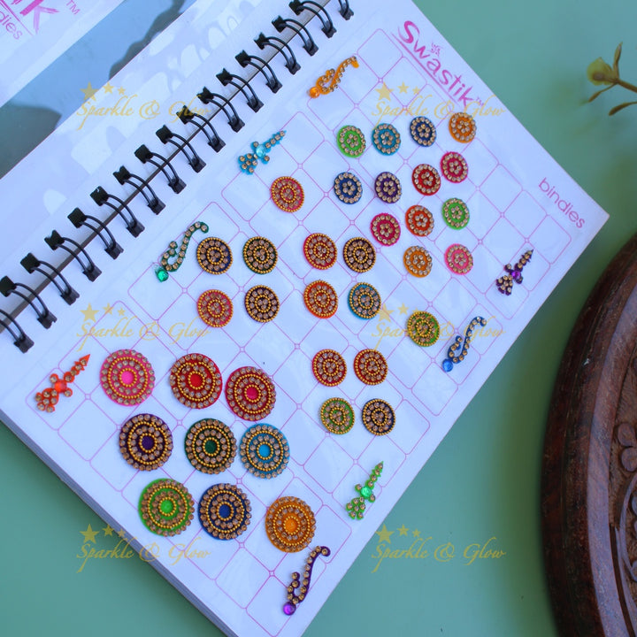 Swastik bridal stone bindi with different shape and size in spiral book in assorted colours