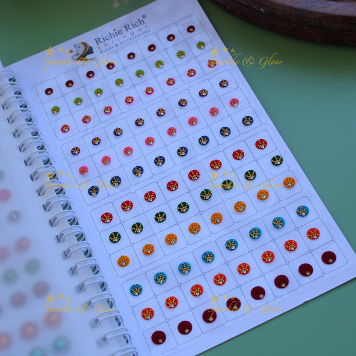 Richie Rich round single stone and different design bindi with different size in spiral book in assorted colours