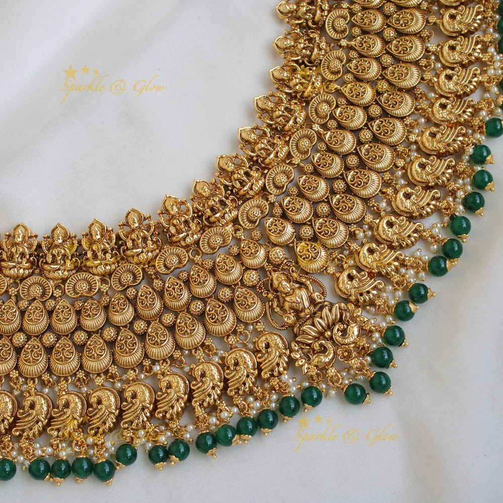 Grand intricate Lakshmi peacock bridal choker with green beads with maang tikka - Sparkle and Glow